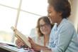 © Kostiantyn - Portrait of enthusiastic mixed race teen girl reading aloud during a lesson with her female teacher at home