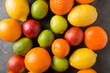 © Screen moment/Stocksy - Citrus fruits on gray abstract background. Orange, lemon, grapefruit, mandarin, lime. Mixed festive colorful tropical and citrus fruit. Healthy eating photo concept. Copyspace