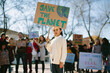 © Jimena Roquero/Stocksy - Young girl carrying a banner