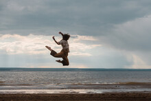 Professional Dancer Jumping High On The Beach