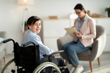 Portrait Of Happy Disabled Teen Boy In Wheelchair Looking At Camera And Smiling, Copy Space