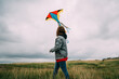 © Vradiy Art/Stocksy - Woman with colorful kite