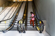 © Mauro Grigollo Photographer/Stocksy - Black man using a mobile phone on escalator