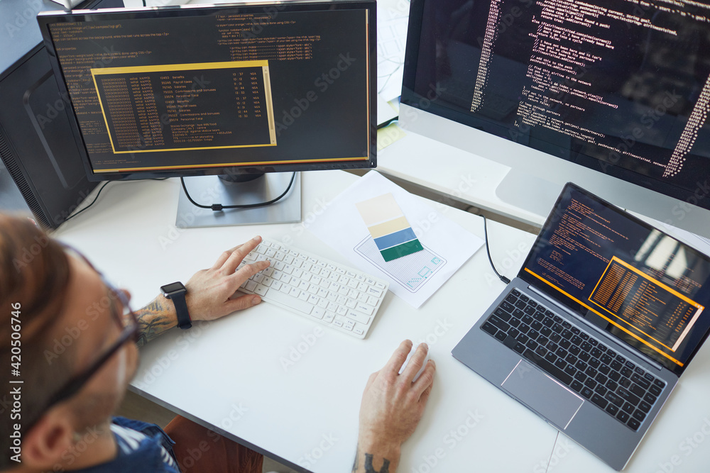 IT Programmer Using Computers with Code on Screen Stock Photo | Adobe Stock