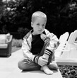 © Jakob Lagerstedt/Stocksy - Cute young boy sitting by a firepit