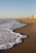 Ocean Foam On A Quiet Beach At Sunrise