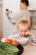 © Alina Hvostikova/Stocksy - Boy eating lunch in kitchen