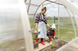 © Alina Hvostikova/Stocksy - Mother and son working in greenhouse