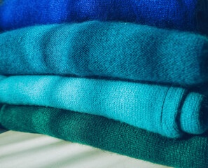 stack of blue to green gradient cachemire clothes