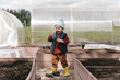 © Alina Hvostikova/Stocksy - Little boy with tools in garden