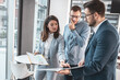 © BalanceFormCreative - Group of company coworkers at the office discuss about business strategy of new investments.