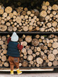 © Alina Hvostikova/Stocksy - Anonymous kid taking logs from shelf