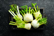Fresh organic fennel bulbs in a wooden box. Healthy food. Top view. Free space for your text.