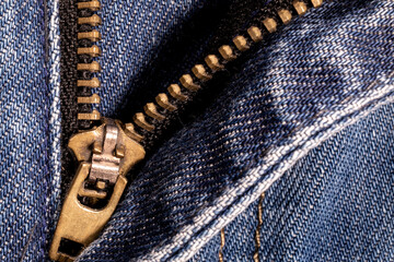 Jeans background. Denim fabric with seams close-up.