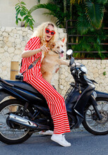 Portrait Of A Photographer Woman With Her Dog On A Motorcycle