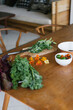 © Dreamwood Photography/Stocksy - Table with various ingredients for salad