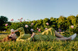 © Sergey Narevskih/Stocksy - Young woman relaxing on green lawn in park