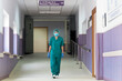 © Nunez Image/Stocksy - Portrait of Female Doctor Walking in Hallway