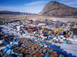 © Adam Sébire/Stocksy - Greenland waste dump for fossil fuels, oil barrels, trash and rubbish disposal
