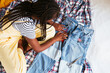 © BONNINSTUDIO/Stocksy - Anonymous ethnic teenager applying patch on jeans