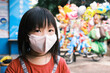 © Pansfun Images/Stocksy - Child wear protective mask on street