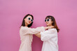 © Pansfun Images/Stocksy - funny portrait of two fashionable women