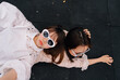 © Pansfun Images/Stocksy - funny portrait of two fashionable women