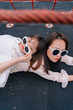 © Pansfun Images/Stocksy - funny portrait of two fashionable women