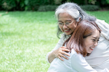 Portrait images of Asian elderly mother is embraced the daughter, are smile with happiness, to relationship in family and health care concept.