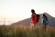 © Casey Crafford/Stocksy - Couple Hiking at sunset