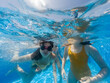 © Marco Govel/Stocksy - Little girls playing in the pool