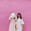 © Pansfun Images/Stocksy - funny portrait of two fashionable women