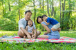 © yuko hirao/Stocksy - Asian family laughing in the park
