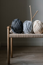 Natural Yarn And Wooden Knitting Needles On Chair