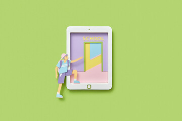 Paper schoolboy enters at school door on a tablet.