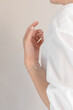 © Alena Vinokurova/Stocksy - woman's hand wearing silver bracelet