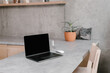 © Alina Hvostikova/Stocksy - Laptop on table in modern minimalist workplace