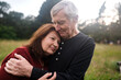 © Rob and Julia Campbell/Stocksy - Affectionate older couple spending time together in a park.