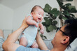 © MaaHoo Studio/Stocksy - Asian father lifting baby son