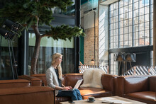 Businesswoman Using Laptop In The Hotel Lobby