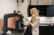 © Hernandez & Sorokina/Stocksy - Woman Making Cofee In The Kitchen