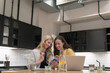 © Hernandez & Sorokina/Stocksy - Two Women Using Smartphone Indoors