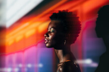 Black African Woman Posing In The Studio With Colorful Lights
