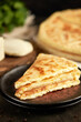 © Savory - National traditional Caucasian cuisine: Ossetian pies, khachapuri, chudu. Assorted pies with different fillings: meat, cheese, herbs