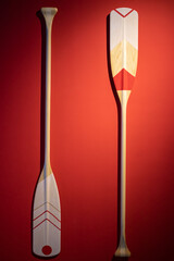 Oars on a red background.