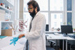 © Hernandez & Sorokina/Stocksy - Scientist Putting On The Gloves