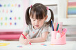 © M-image - young girl practice drawing different shapes  for homeschooling