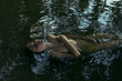 © Demetr White/Stocksy - portrait of a girl without clothes in glowing water
