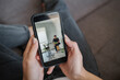 © Hernandez & Sorokina/Stocksy - Woman Hands Holding Cellphone With Concert Online