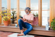 © BONNINSTUDIO/Stocksy - Relaxed mature man texting in a sunny terrace